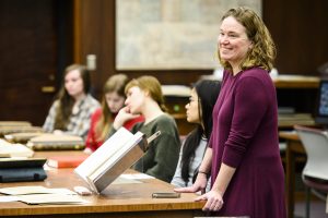 Anna Andrzejewski with students at a table of archival materials at the Wisconsin Historical Society