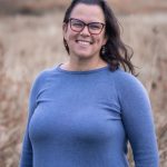 Portrait of Jennie Maunnamalai outdoors in a blue weater