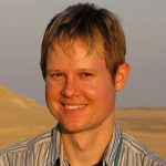 Portrait of Shanan Peters outdoors in a collared shirt